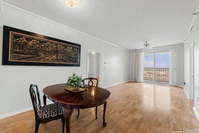 1 Towers Park Ln Unit 1108, San Antonio, TX 78209 - dining space featuring a ceiling fan, light wood-style floors, baseboards, crown molding, and a textured ceiling