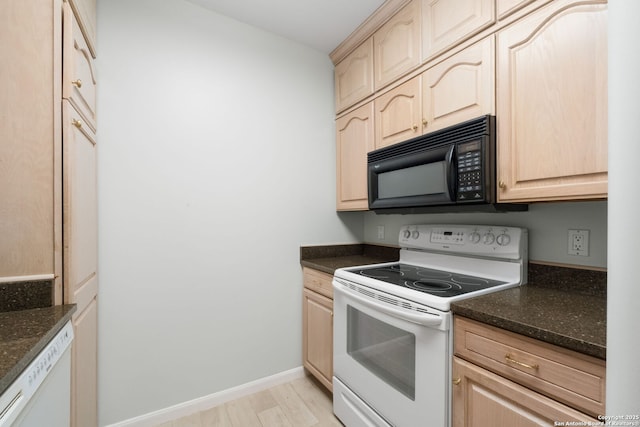1 Towers Park Ln Unit 1108, San Antonio, TX 78209 - kitchen with white appliances, light brown cabinetry, and dark stone counters