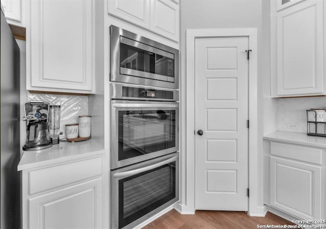 2818 Tortuga Verde, San Antonio, TX 78245 - kitchen with appliances with stainless steel finishes, tasteful backsplash, white cabinets, and light countertops