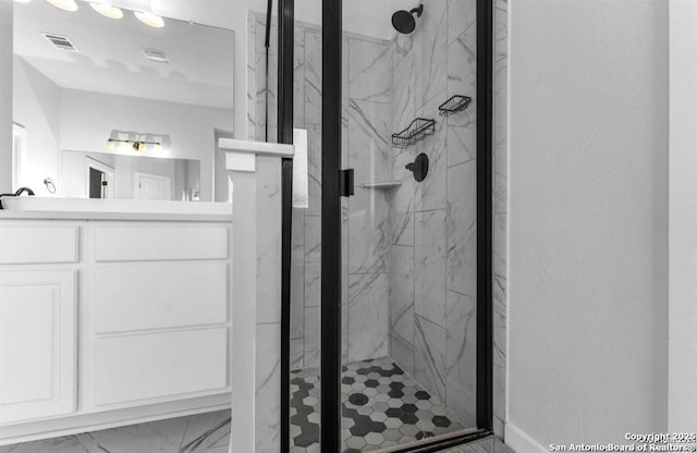 2818 Tortuga Verde, San Antonio, TX 78245 - full bath with a marble finish shower, marble look tile flooring, vanity, and a textured wall