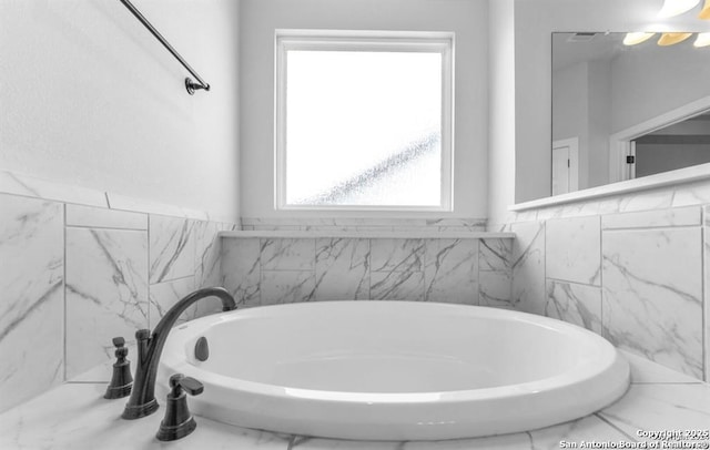 2818 Tortuga Verde, San Antonio, TX 78245 - bathroom featuring a garden tub and marble finish floors