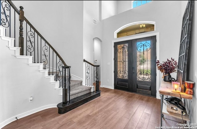 2818 Tortuga Verde, San Antonio, TX 78245 - foyer featuring wood finished floors, french doors, stairway, baseboards, and a towering ceiling