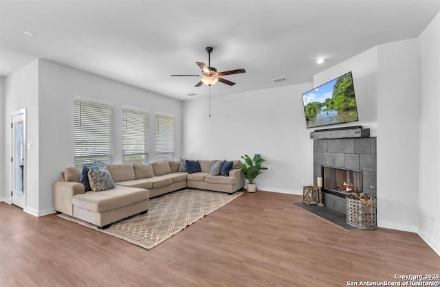 2818 Tortuga Verde, San Antonio, TX 78245 - living area with ceiling fan, wood finished floors, baseboards, and a tiled fireplace