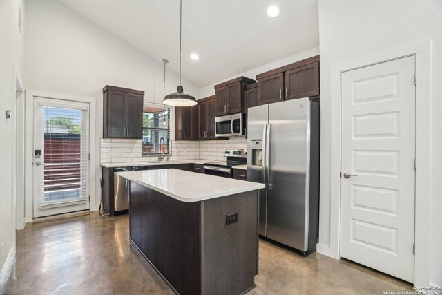 1130 N Olive St, San Antonio, TX 78202 - kitchen featuring stainless steel appliances, dark brown cabinets, backsplash, a kitchen island, and hanging light fixtures