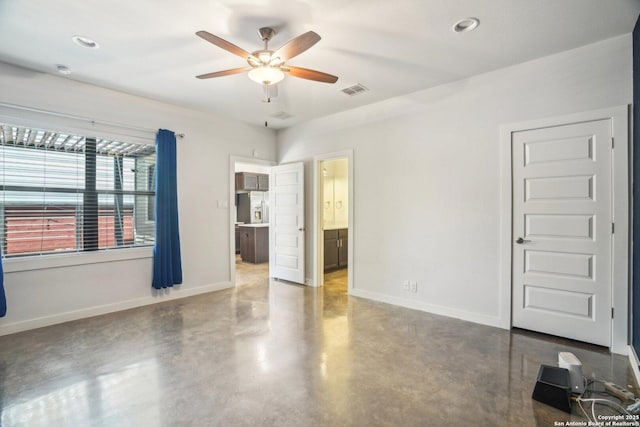1130 N Olive St, San Antonio, TX 78202 - unfurnished bedroom with concrete flooring, baseboards, ceiling fan, connected bathroom, and recessed lighting