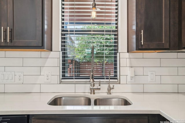 1130 N Olive St, San Antonio, TX 78202 - kitchen with dark brown cabinetry, backsplash, light countertops, and a sink