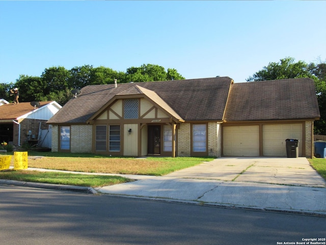 12226 E Valley Frg, San Antonio, TX 78233 - english style home featuring a garage, brick siding, concrete driveway, and a front yard