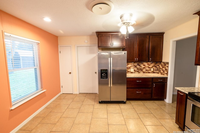 902 Newhall, Beeville, TX 78102 - kitchen featuring stainless steel appliances, a ceiling fan, tasteful backsplash, dark brown cabinets, and light stone countertops