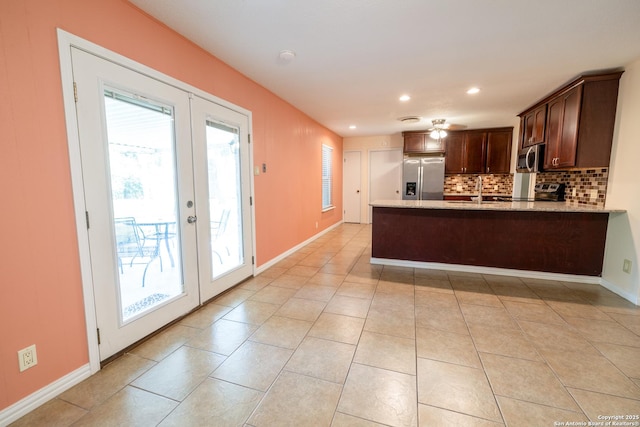 902 Newhall, Beeville, TX 78102 - kitchen featuring stainless steel appliances, french doors, backsplash, a peninsula, and dark brown cabinetry