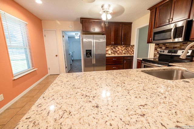 902 Newhall, Beeville, TX 78102 - kitchen featuring stainless steel appliances, a sink, light tile patterned floors, light stone countertops, and recessed lighting