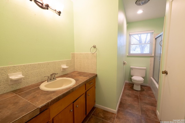 902 Newhall, Beeville, TX 78102 - bathroom with vanity, toilet, tile patterned flooring, and enclosed tub / shower combo