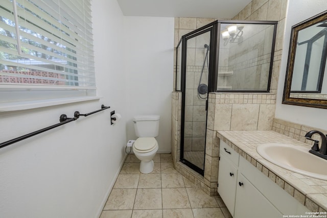 902 Newhall, Beeville, TX 78102 - full bathroom featuring vanity, toilet, a stall shower, and baseboards