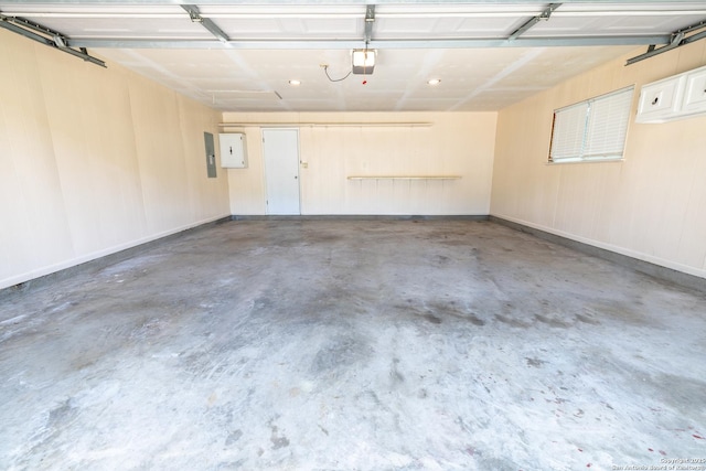 902 Newhall, Beeville, TX 78102 - garage featuring recessed lighting, electric panel, and a garage door opener
