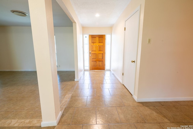902 Newhall, Beeville, TX 78102 - corridor featuring baseboards and light tile patterned floors