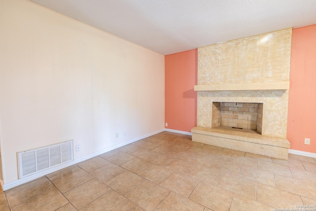 902 Newhall, Beeville, TX 78102 - unfurnished living room with a large fireplace, baseboards, and tile patterned flooring