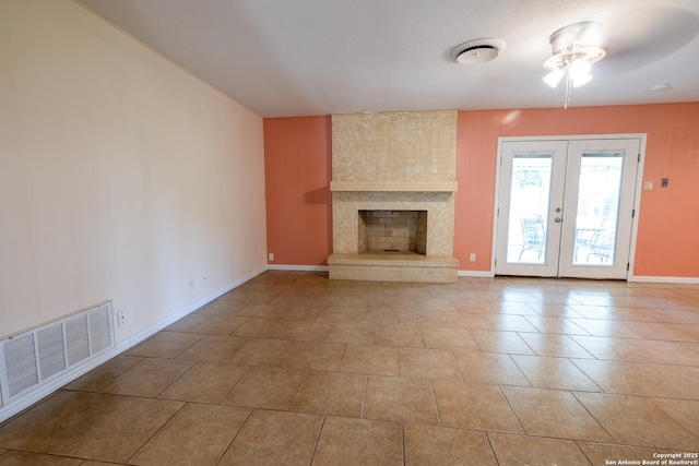 902 Newhall, Beeville, TX 78102 - unfurnished living room with ceiling fan, baseboards, french doors, and tile patterned flooring