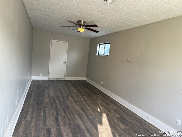 130 Nedrub Dr, San Antonio, TX 78223 - empty room with dark wood-style flooring, a ceiling fan, and baseboards