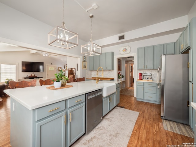 2275 Huber Rd, Seguin, TX 78155 - kitchen featuring appliances with stainless steel finishes, a sink, a chandelier, open floor plan, and ceiling fan
