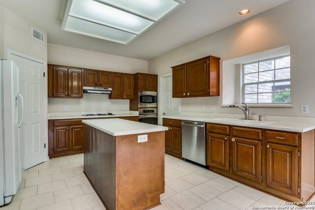 2614 Inwood Vw, San Antonio, TX 78248 - kitchen with stainless steel appliances, a sink, under cabinet range hood, a center island, and light countertops