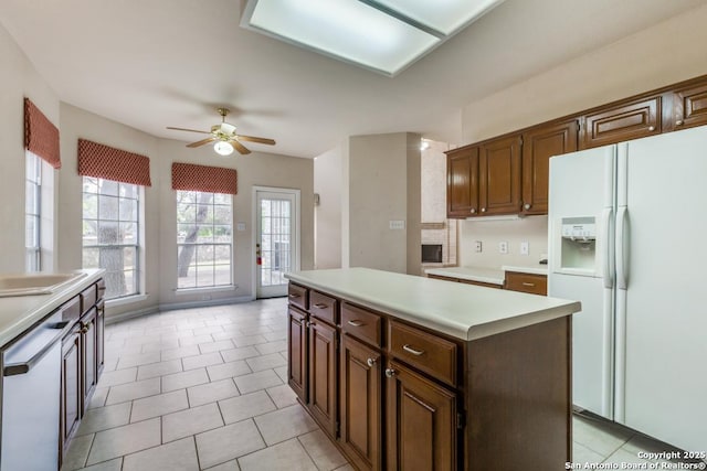 2614 Inwood Vw, San Antonio, TX 78248 - kitchen with white fridge with ice dispenser, a kitchen island, light countertops, ceiling fan, and light tile patterned floors