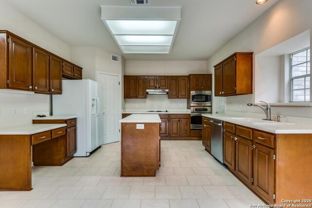 2614 Inwood Vw, San Antonio, TX 78248 - kitchen with stainless steel appliances, under cabinet range hood, a kitchen island, a sink, and light countertops
