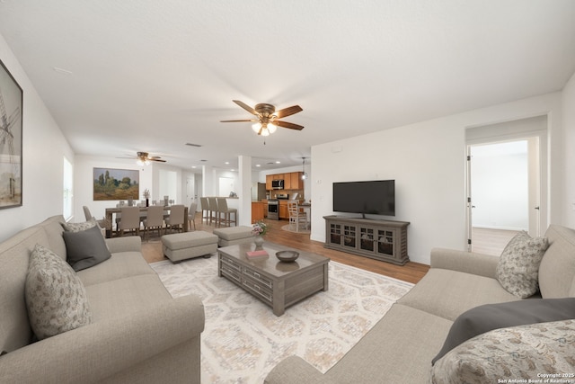 10911 Shoo Fly Trl, San Antonio, TX 78245 - living room featuring ceiling fan and light wood finished floors