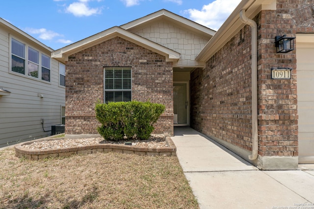 10911 Shoo Fly Trl, San Antonio, TX 78245 - property entrance with brick siding and an attached garage