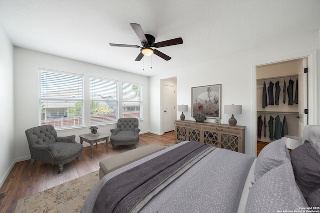10911 Shoo Fly Trl, San Antonio, TX 78245 - bedroom with wood finished floors, baseboards, and a ceiling fan