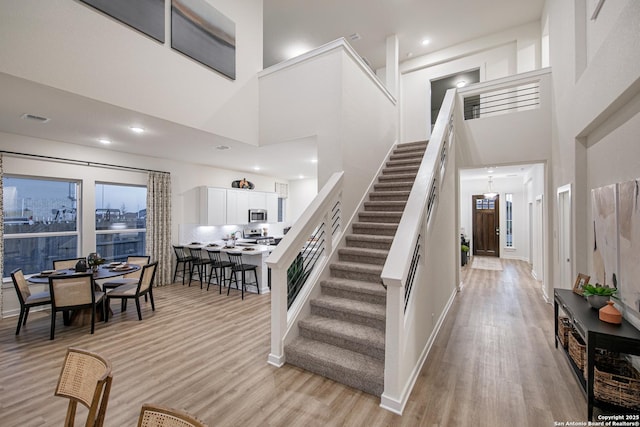 547 White Oak, Castroville, TX 78009 - stairway with a high ceiling, wood finished floors, recessed lighting, and baseboards