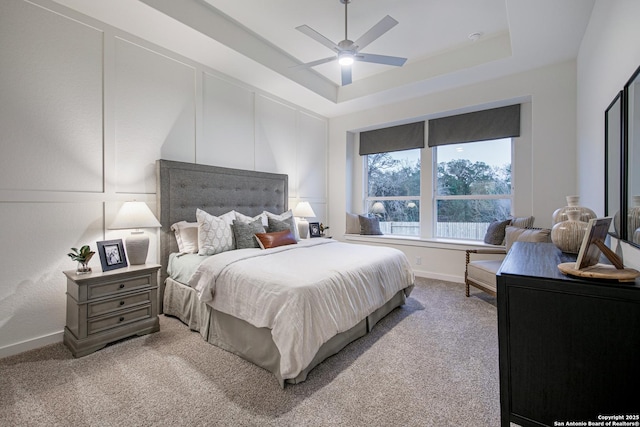 547 White Oak, Castroville, TX 78009 - carpeted bedroom with a tray ceiling, baseboards, and ceiling fan