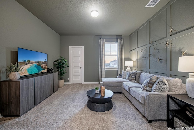 547 White Oak, Castroville, TX 78009 - carpeted living room featuring a textured ceiling and baseboards