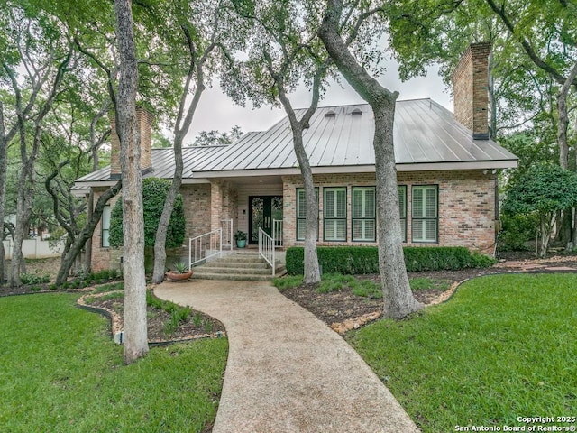 11607 Elm Rdg, San Antonio, TX 78230 - view of front of property featuring a chimney, a standing seam roof, brick siding, and a front yard
