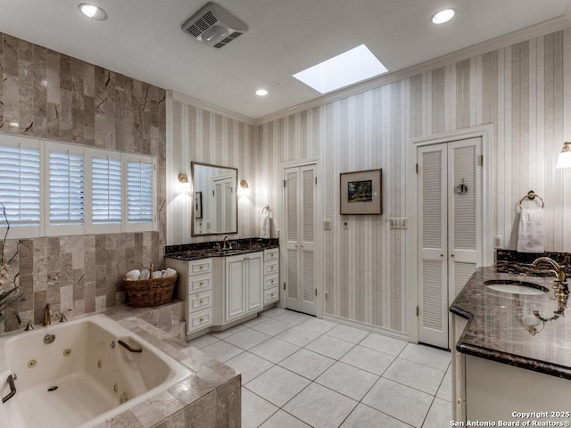 11607 Elm Rdg, San Antonio, TX 78230 - bathroom featuring a skylight, two vanities, a jetted tub, tile patterned floors, and ornamental molding
