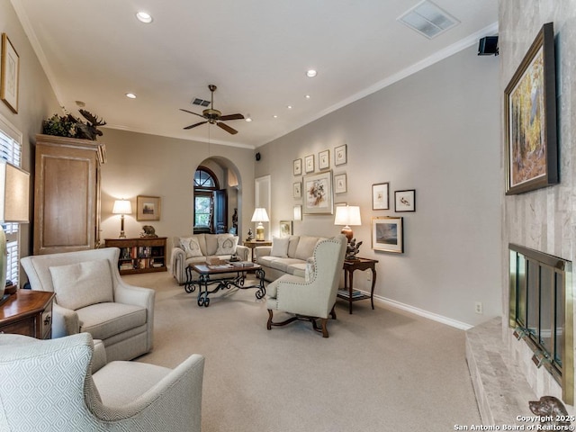 11607 Elm Rdg, San Antonio, TX 78230 - living area with crown molding, arched walkways, light colored carpet, recessed lighting, and baseboards