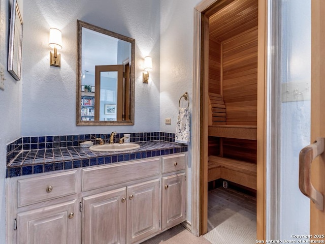 11607 Elm Rdg, San Antonio, TX 78230 - bathroom with a textured wall, vanity, and a sauna