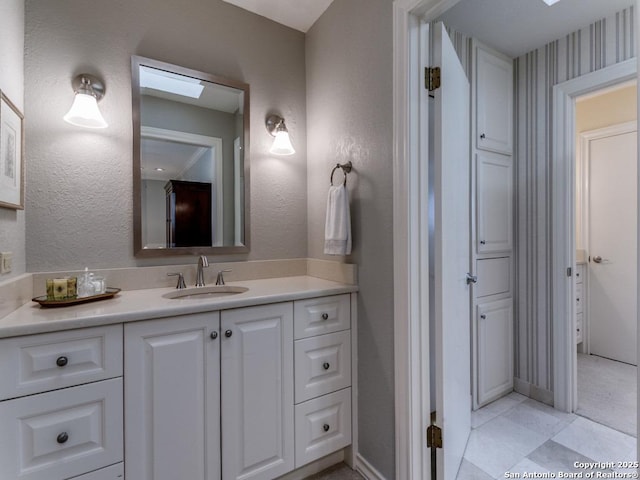 11607 Elm Rdg, San Antonio, TX 78230 - bathroom with vanity, a skylight, and tile patterned floors