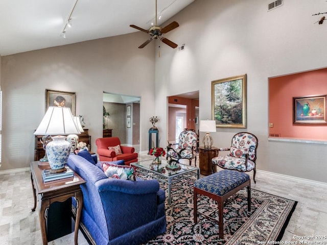 11607 Elm Rdg, San Antonio, TX 78230 - living room featuring rail lighting, a ceiling fan, high vaulted ceiling, and baseboards