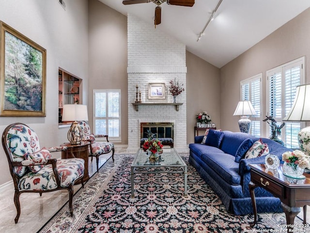 11607 Elm Rdg, San Antonio, TX 78230 - living room featuring track lighting, a ceiling fan, healthy amount of natural light, a fireplace, and high vaulted ceiling