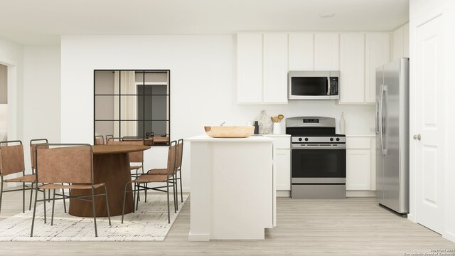 1022 Graham Bnd, San Antonio, TX 78221 - kitchen featuring appliances with stainless steel finishes, light wood-style floors, white cabinets, and light countertops