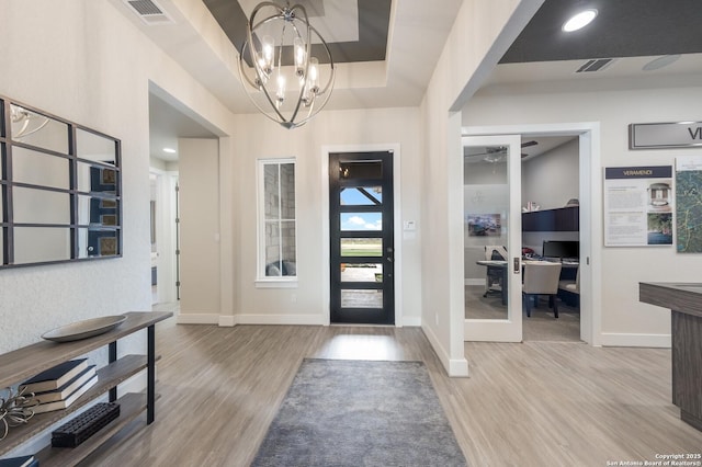 379 Borchers Blvd, New Braunfels, TX 78132 - entryway featuring wood finished floors, a chandelier, and baseboards