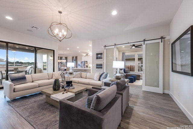 379 Borchers Blvd, New Braunfels, TX 78132 - living area with a barn door, dark wood-style flooring, a chandelier, baseboards, and recessed lighting