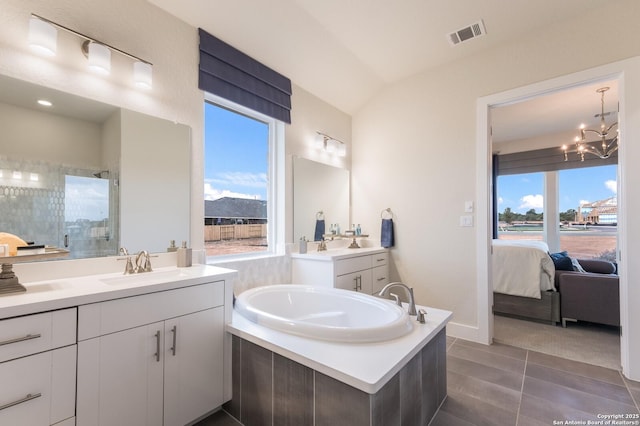 379 Borchers Blvd, New Braunfels, TX 78132 - bathroom featuring tiled shower, a garden tub, connected bathroom, two vanities, and healthy amount of natural light