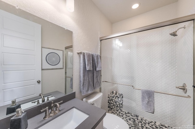 379 Borchers Blvd, New Braunfels, TX 78132 - bathroom featuring a shower stall, vanity, toilet, and a textured wall