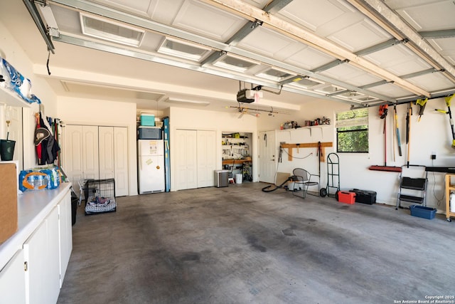 1804 Athens Ave, Kerrville, TX 78028 - garage featuring a garage door opener and freestanding refrigerator