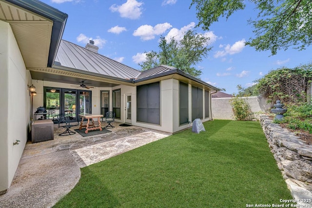 1804 Athens Ave, Kerrville, TX 78028 - rear view of house featuring a standing seam roof, a ceiling fan, a chimney, a patio, and metal roof