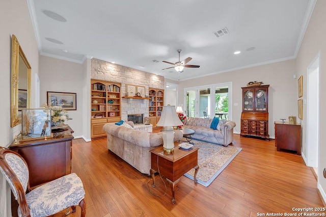 1804 Athens Ave, Kerrville, TX 78028 - living area featuring ceiling fan, light wood-style floors, crown molding, a fireplace, and baseboards