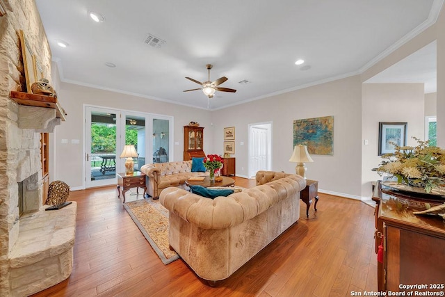 1804 Athens Ave, Kerrville, TX 78028 - living room featuring ceiling fan, light wood finished floors, a fireplace, crown molding, and recessed lighting
