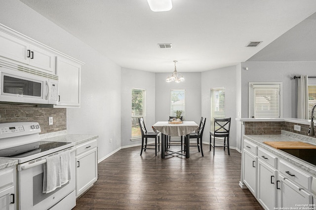 7027 Heathers Way, San Antonio, TX 78227 - kitchen with white appliances, decorative backsplash, a chandelier, and light countertops