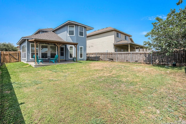 7027 Heathers Way, San Antonio, TX 78227 - back of house with a patio area and a shingled roof