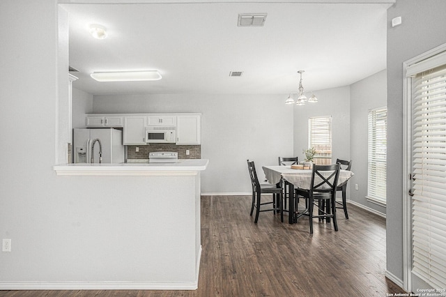 7027 Heathers Way, San Antonio, TX 78227 - dining space featuring dark wood-style flooring, a chandelier, and baseboards